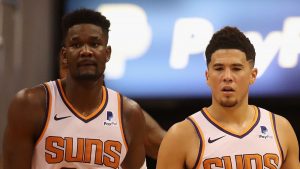 Devin Booker #1 and Deandre Ayton #22 of the Phoenix Suns during the NBA game against the Dallas Mavericks at Talking Stick Resort Arena on October 17, 2018 in Phoenix, Arizona. The Suns defeated defeated the Mavericks 121-100.