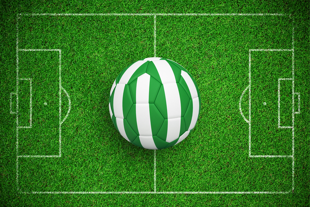 Football in nigeria colours against close up view of astro turf